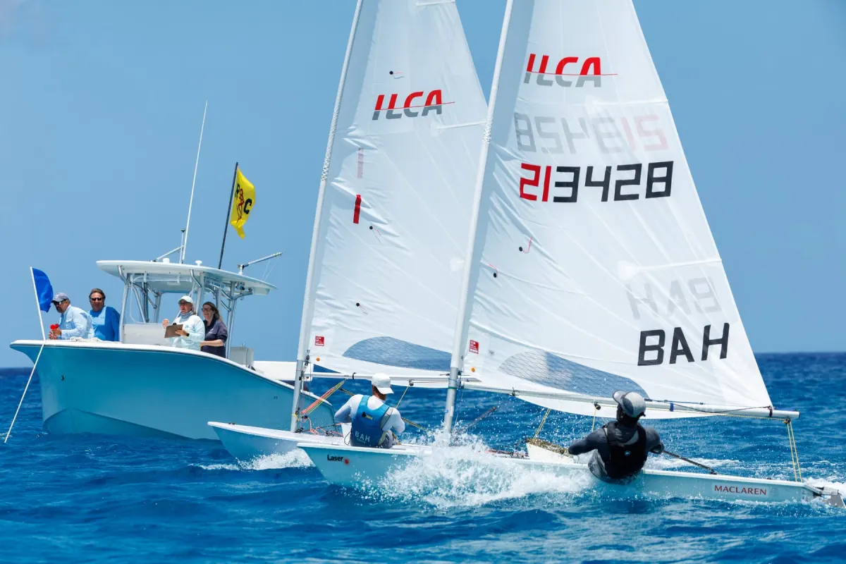 ILCA sailors training in Nassau with a coach boat